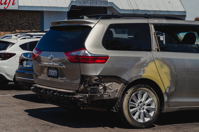 dent Backside of new silver car get damaged by accident
